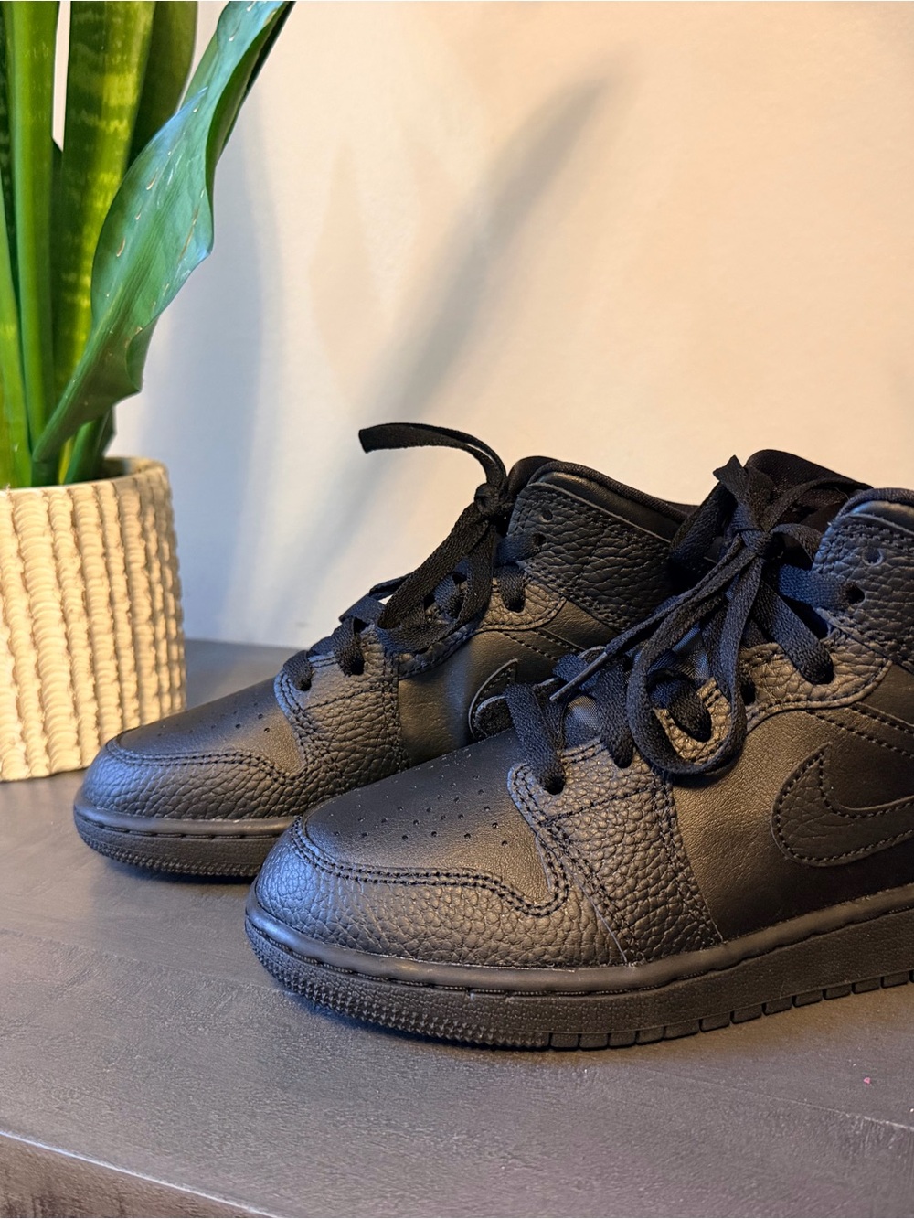 Kids All-Black High-Top Air Jordan 1 Mid Sneakers with Iconic Swoosh